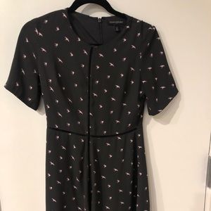 Black short sleeve dress. Has bird design and knit line down middle.